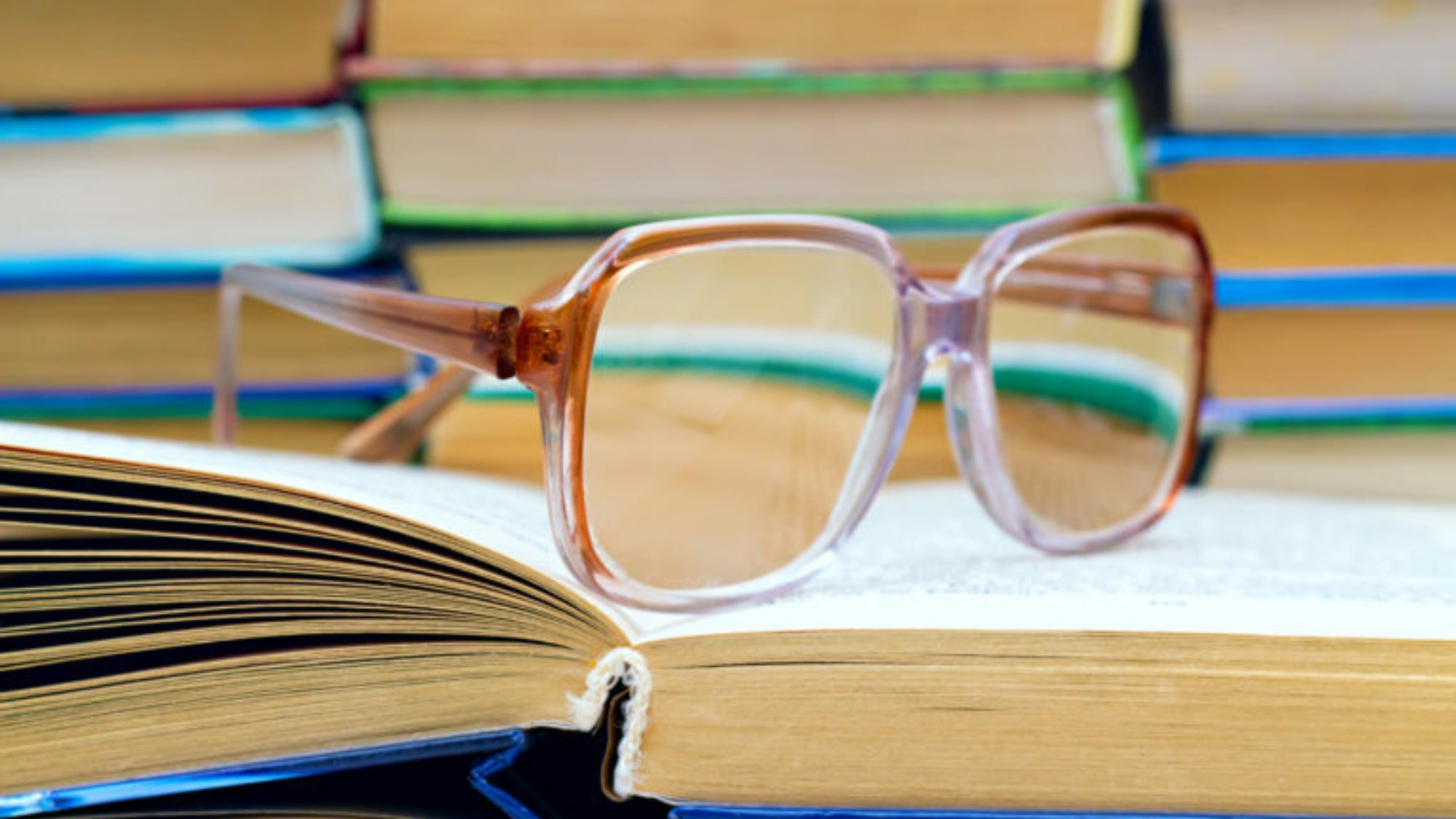 reading glasses lying on the open book